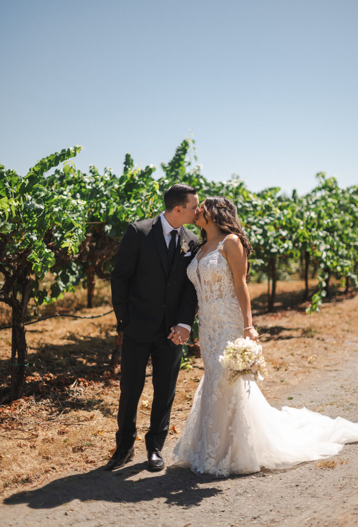 bride and groom kissing during wedding photos