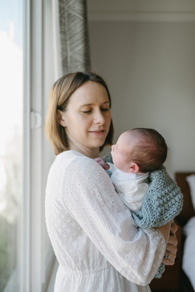 happy mother looking at her beautiful newborn baby girl