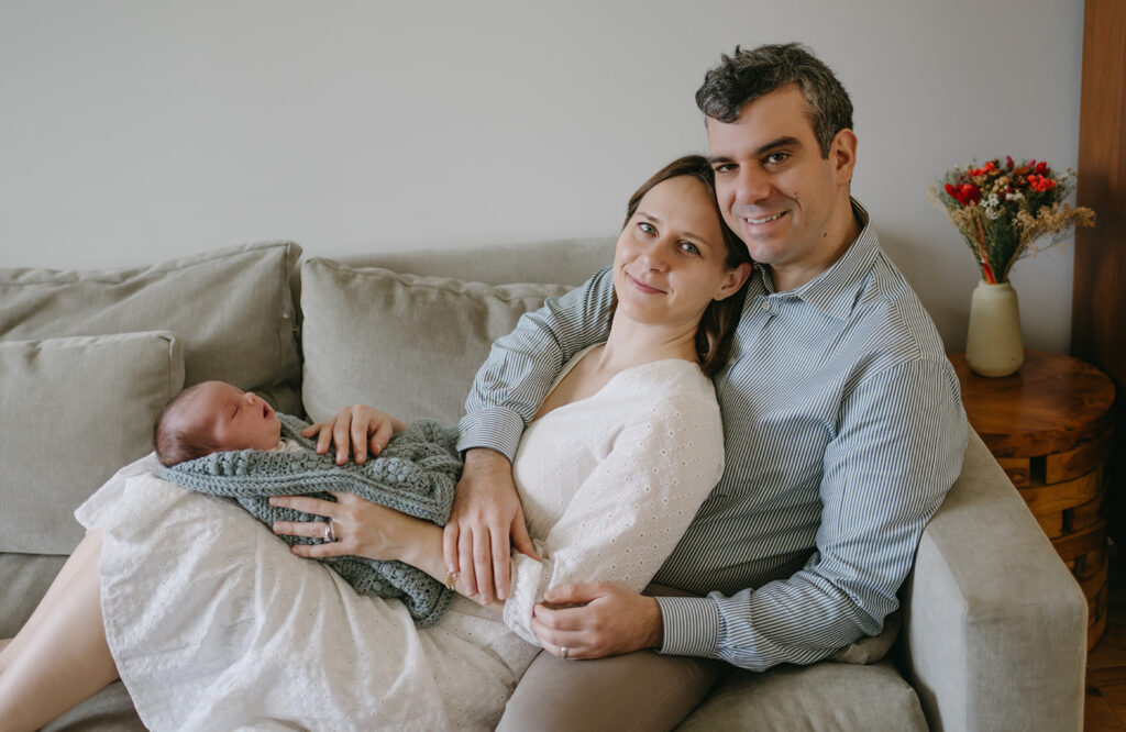 parents holding their newborn baby during their lifestyle photoshoot