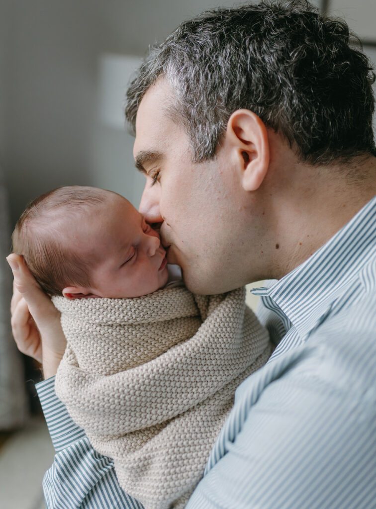 dad kissing his baby on the cheek