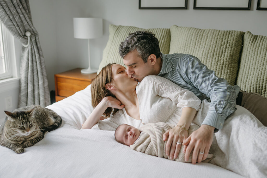 couple kissing during their in home newborn session