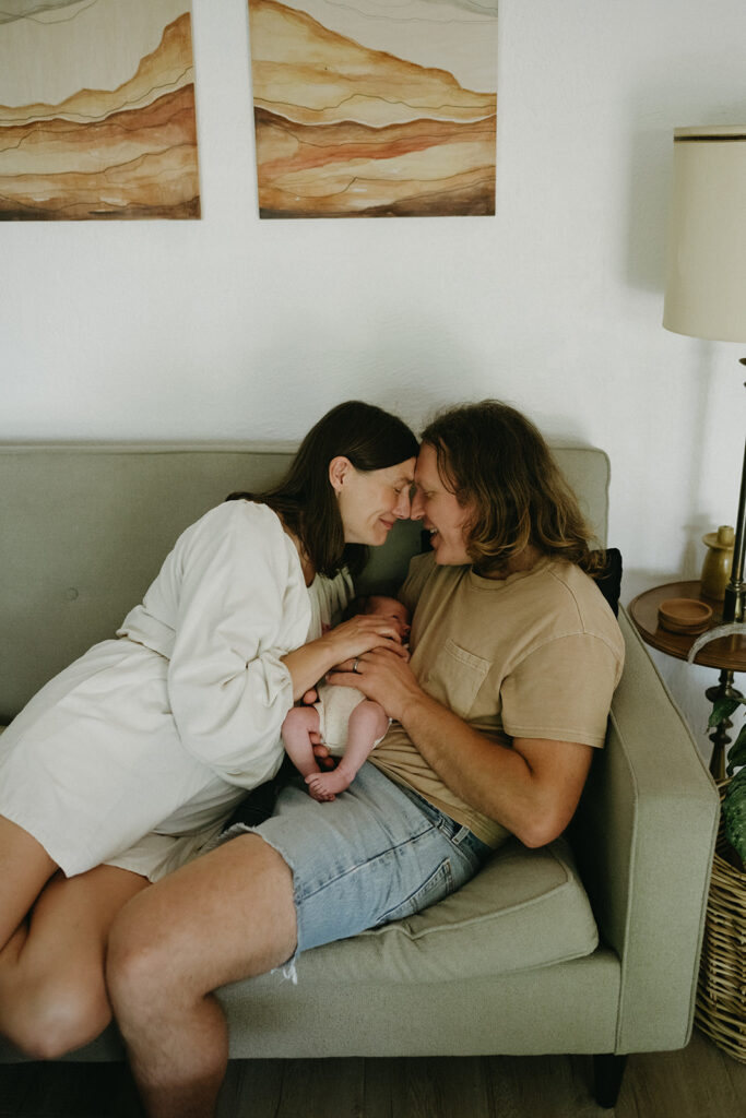 happy couple holding their newborn 