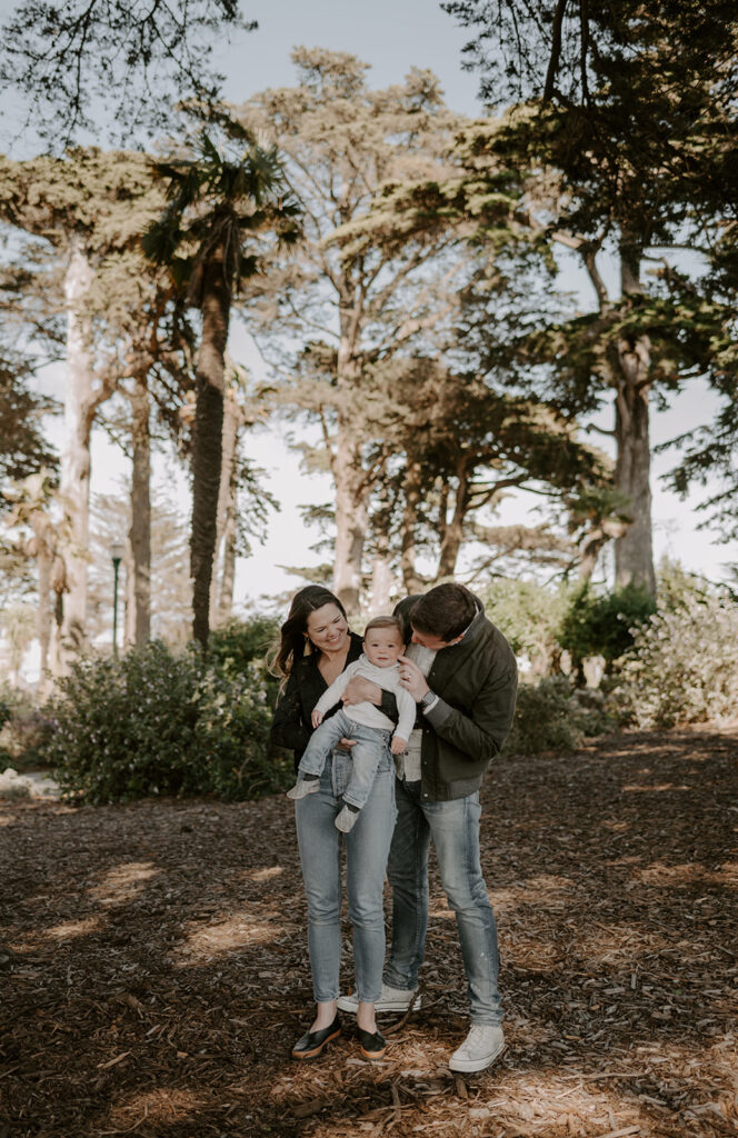 dad kissing his little boy on the cheek during their fall family photoshoot