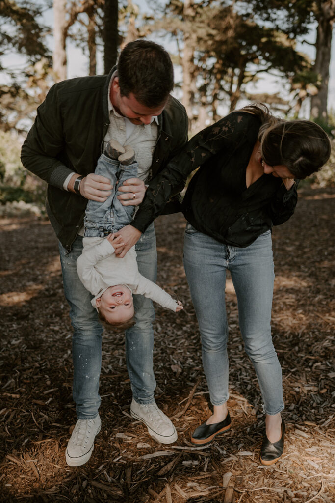 mom and dad playing with their son during their family session