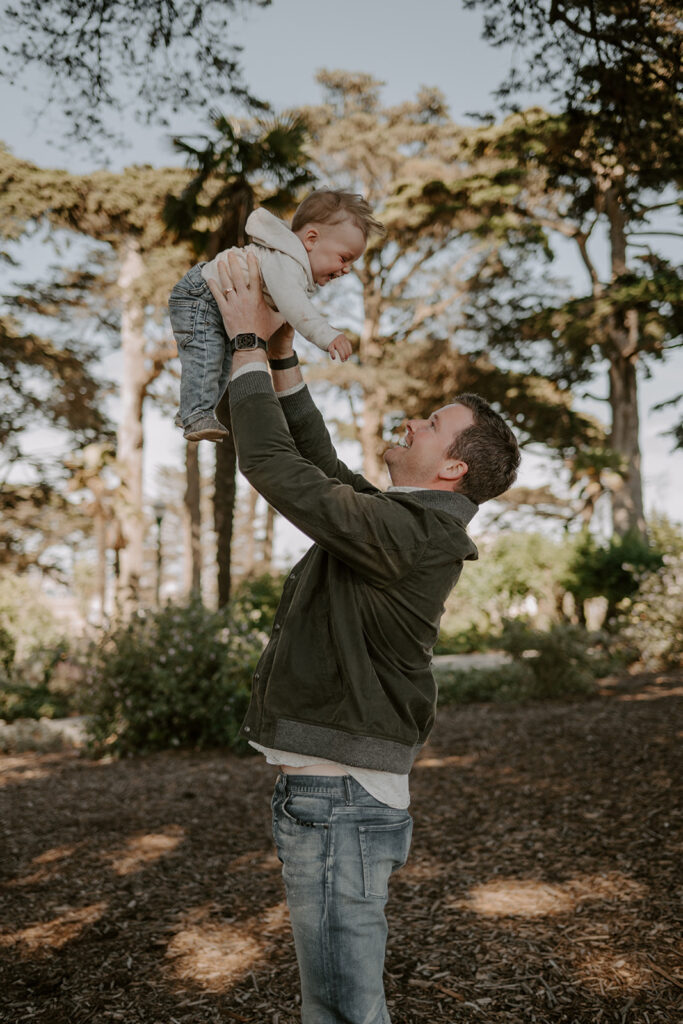 dad holding his little boy during their photoshoot