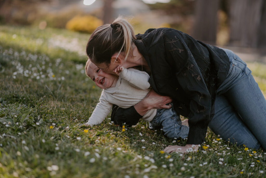 mom playing with her little boy during their fall family photoshoot