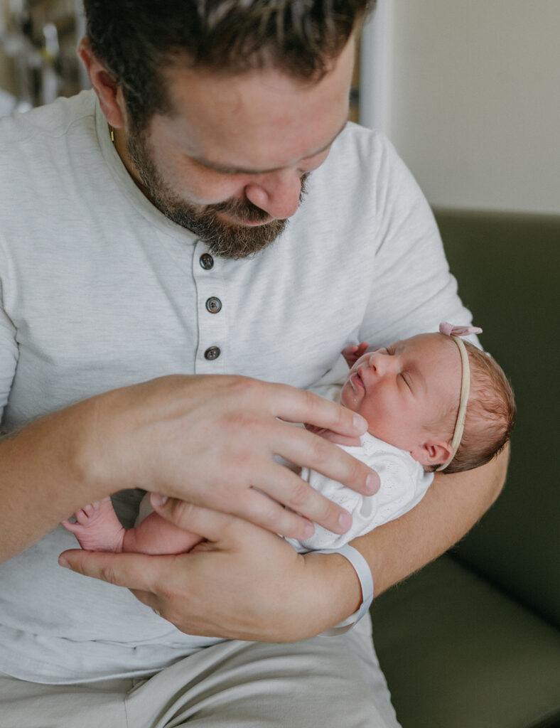 dad holding his newborn daughter