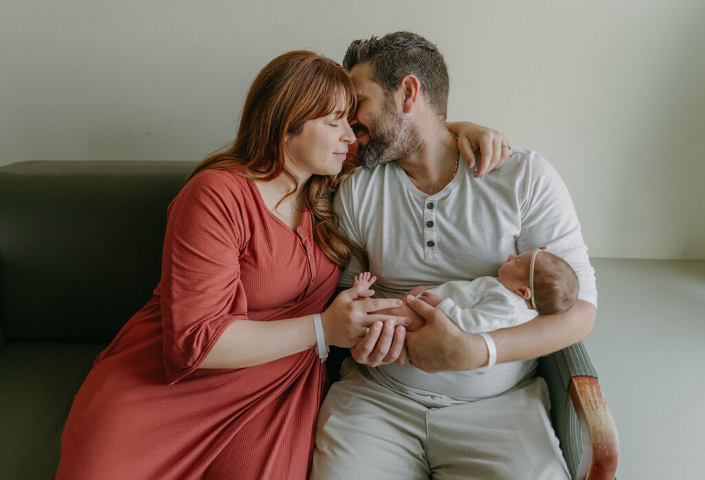 parents holding their newborn baby girl 