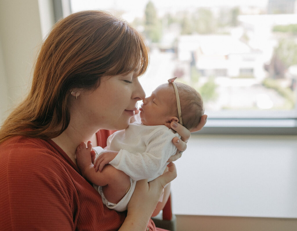 mom holding her newborn baby 